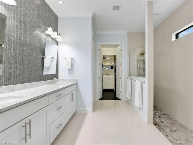 Primary Bathroom With Custom Tile Wall and Custom Mirrors, and Walk-In Closet With Custom Shelving