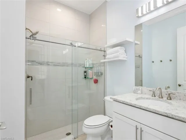 Back Bathroom With Floor To Ceiling Wall Tile & Glass Enclosure