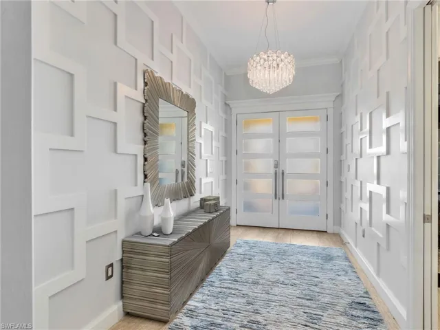 Front Entry with Custom Wall Treatment,  Crystal Chandelier, and Custom Glass Front Door