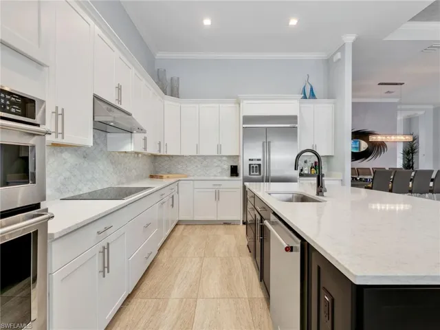 Kitchen With Large Island, Quartz Counters, Marble Backsplash, KitchenAid Stainless Steel Appliances and Built-In Refrigerator