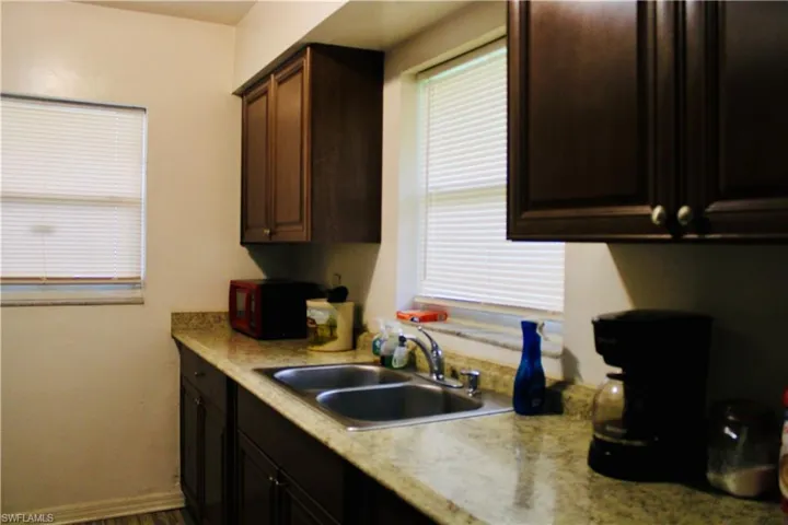 Kitchen with dark brown cabinets and sink