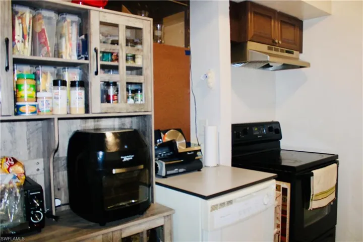 Kitchen with dishwasher and black range with electric cooktop