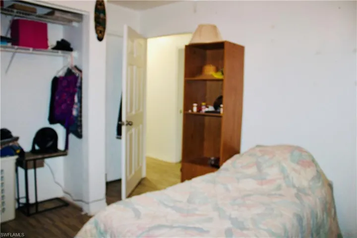 Bedroom featuring wood-type flooring and a closet