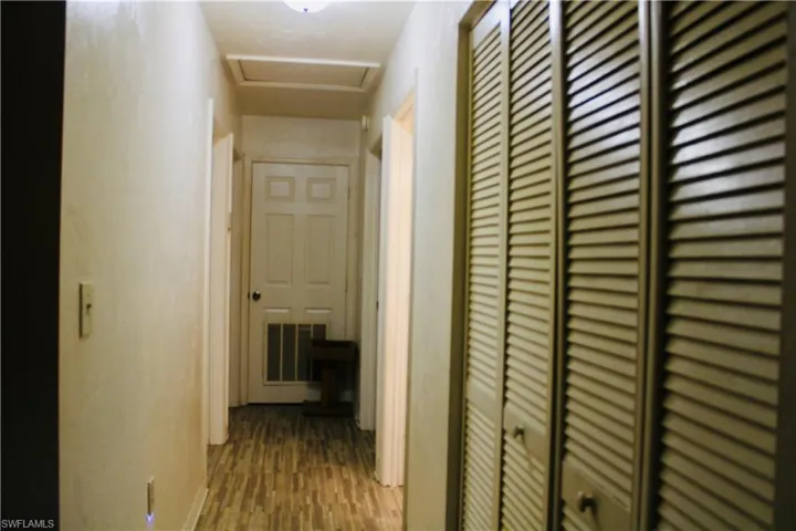 Corridor featuring hardwood / wood-style flooring