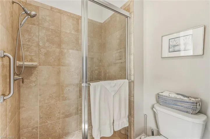 Full bath with a shower stall and toilet