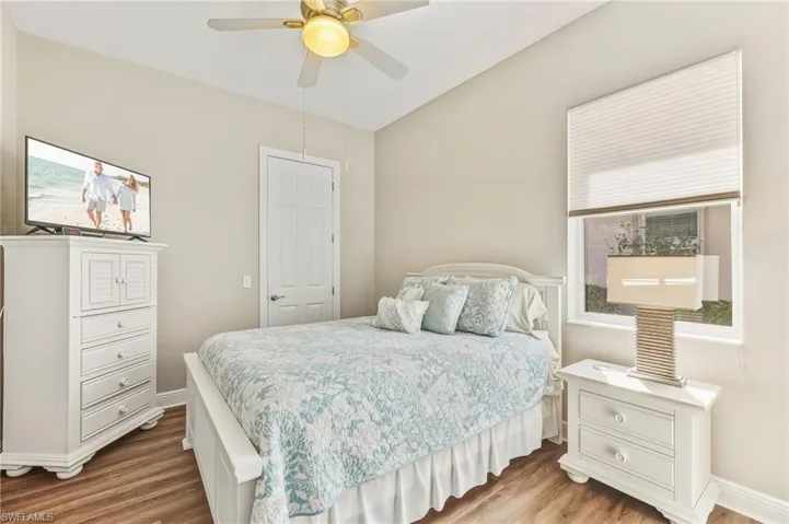 Bedroom with wood finished floors and a ceiling fan