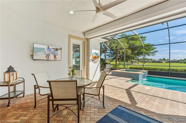 Sunroom with a jacuzzi, a patio, ceiling fan, and outdoor dining area