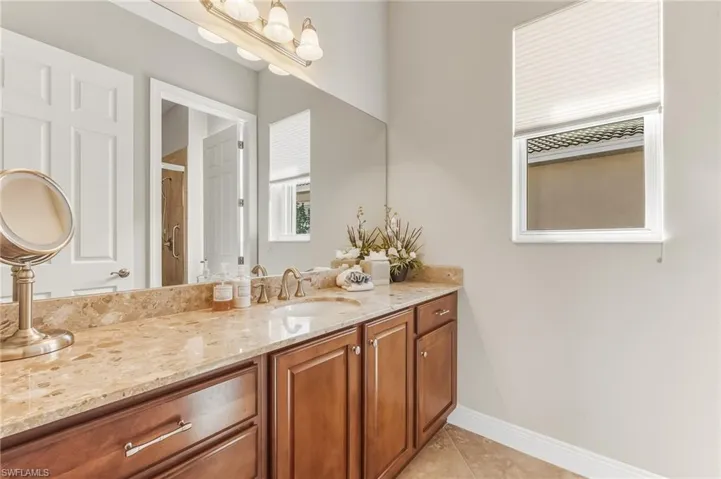 Bathroom with vanity and light tile patterned flooring