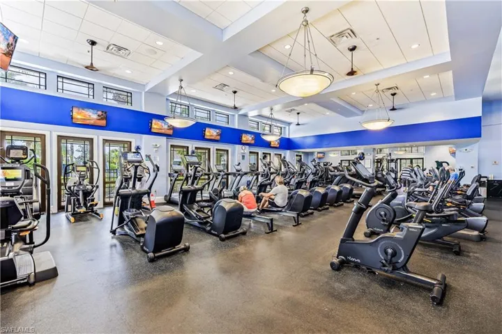 Workout area featuring beam ceiling, coffered ceiling, a towering ceiling, and recessed lighting