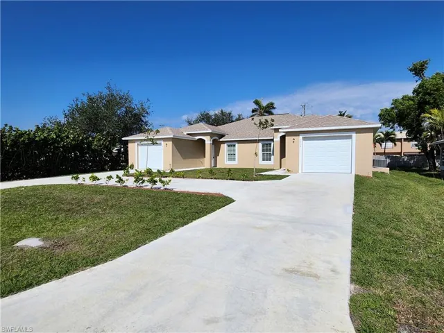 Ranch-style home featuring a garage and a front yard