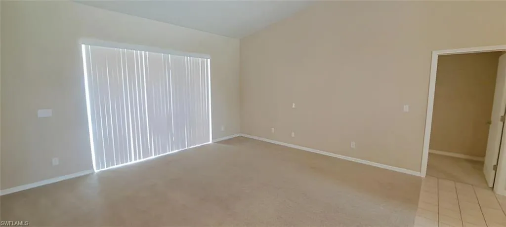 Spare room featuring light carpet