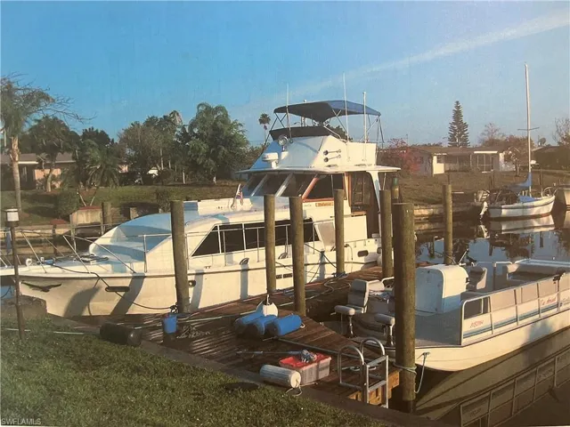 Dock area with a large yacht and also a lift for a smaller boat.
