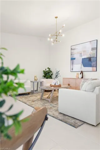 Tiled living area with a notable chandelier