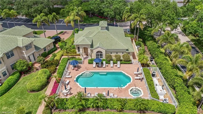 Resort-style pool with integrated spa, surrounded by a brick paver deck