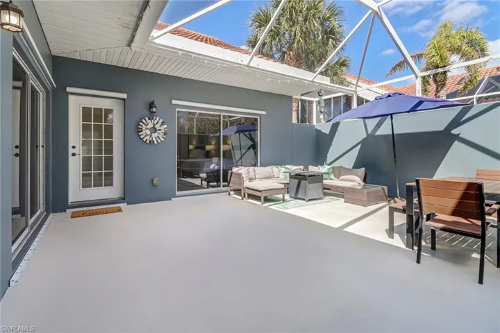 View of patio with a sunroom, a lanai, and outdoor lounge area