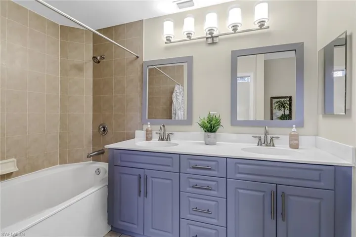 Bathroom with shower / bath combo and double vanity