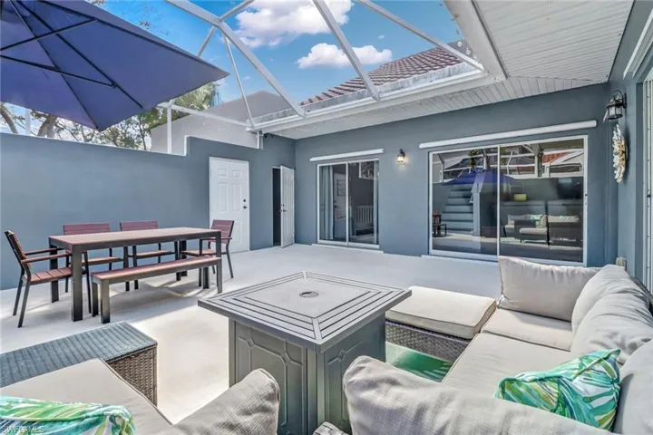View of patio featuring a sunroom, a lanai, outdoor lounge area, and outdoor dining space