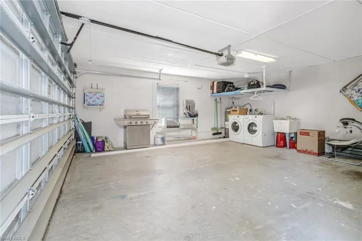 Garage with washing machine and dryer and a garage door opener