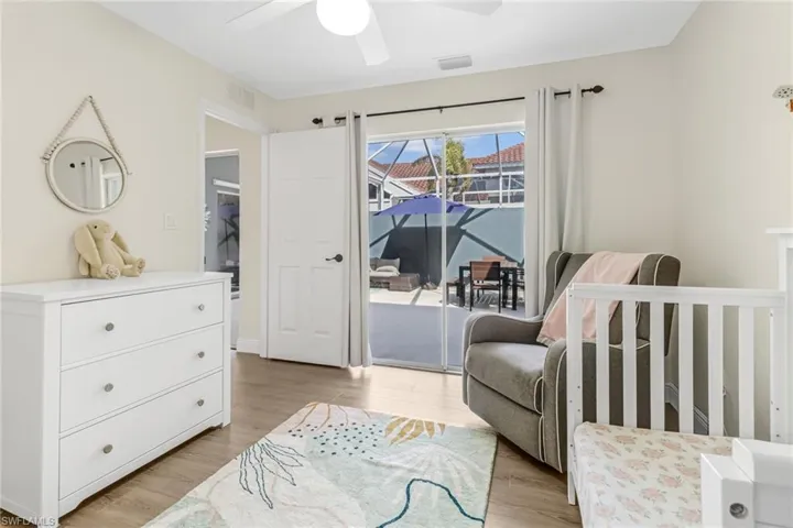 Bedroom with light wood-style flooring, access to outside, and a ceiling fan