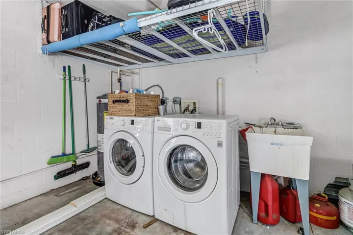 Washroom featuring concrete flooring and independent washer and dryer