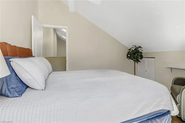 Bedroom featuring vaulted ceiling and ceiling fan