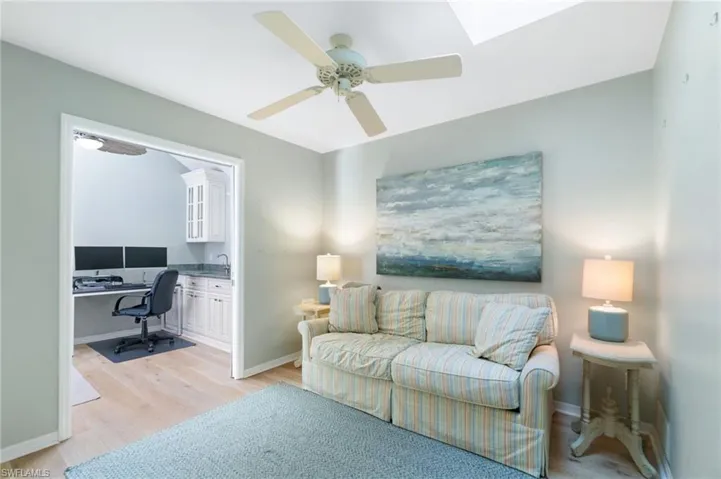 Living room featuring ceiling fan and light hardwood / wood-style flooring