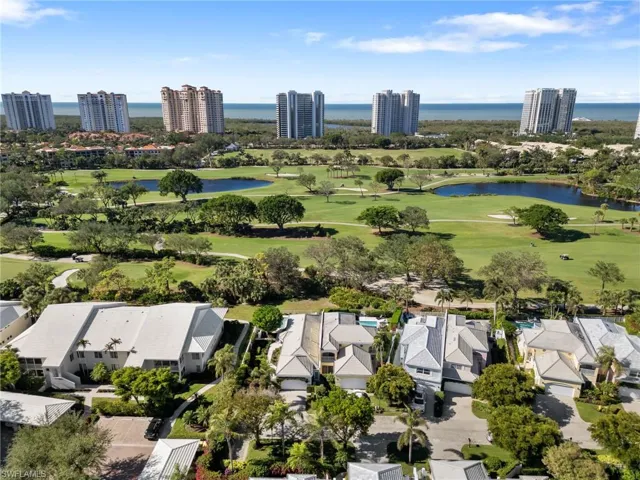 Birds eye view of property with a water view