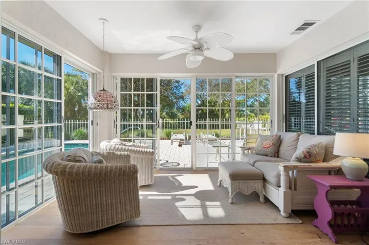 Sunroom / solarium featuring ceiling fan