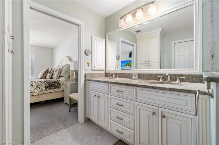 Bathroom with tile patterned flooring and vanity