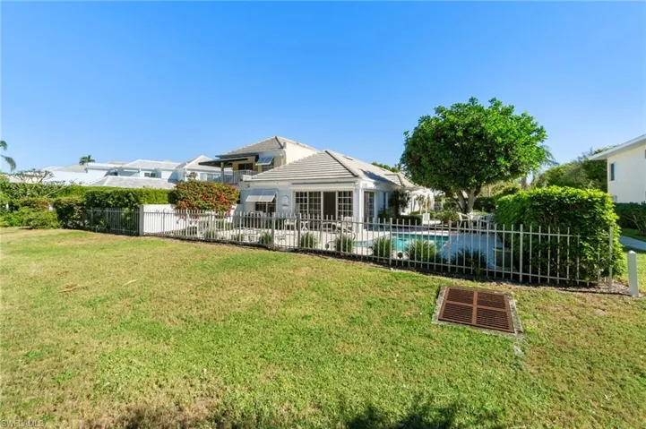 Rear view of house featuring a yard