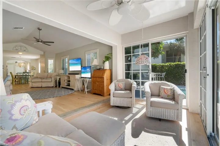 Sunroom featuring vaulted ceiling, ceiling fan, and a healthy amount of sunlight