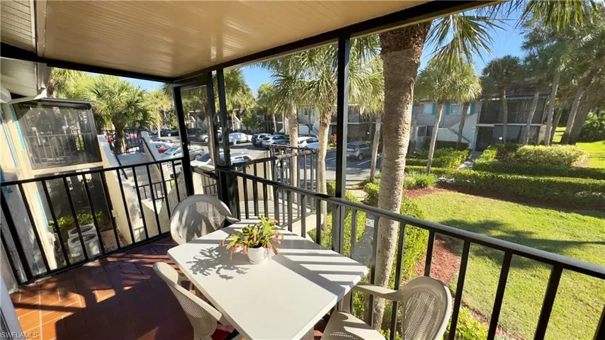 Sunroom featuring plenty of natural light, outdoor dining space, and a balcony