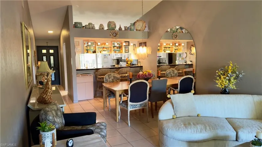 Living room with tile  floors and high vaulted ceiling