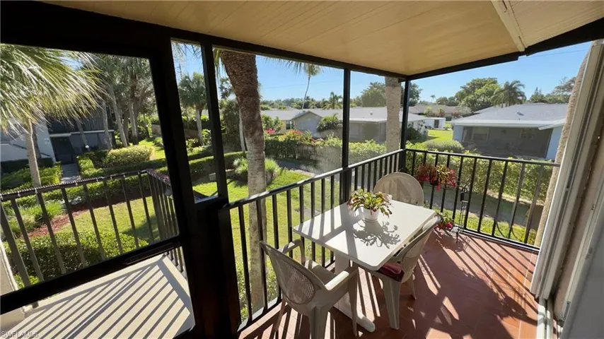 Private screened lanai featuring plenty of natural light and a green space and residential view
