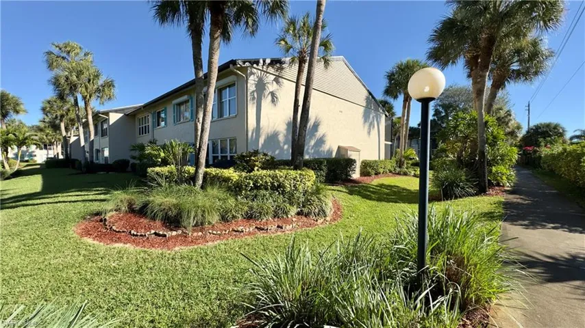 View of home's exterior with stucco siding and a yard