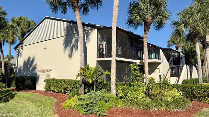 View of side of home featuring a balcony and stucco siding