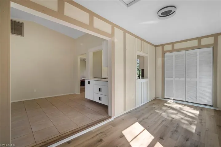 Foyer entrance featuring lofted ceiling and light wood-type flooring