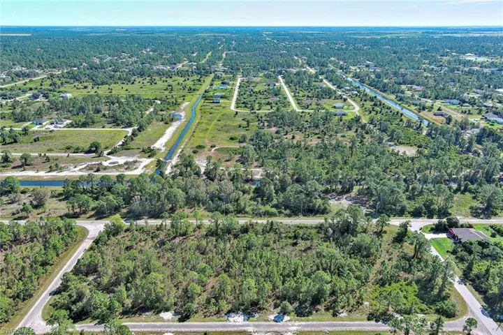 Aerial overview of property's location featuring a forest