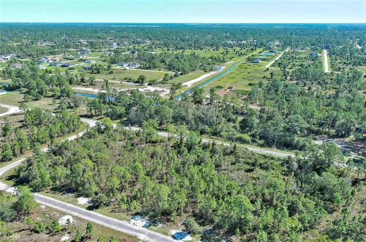 Aerial view of property's location featuring a forest
