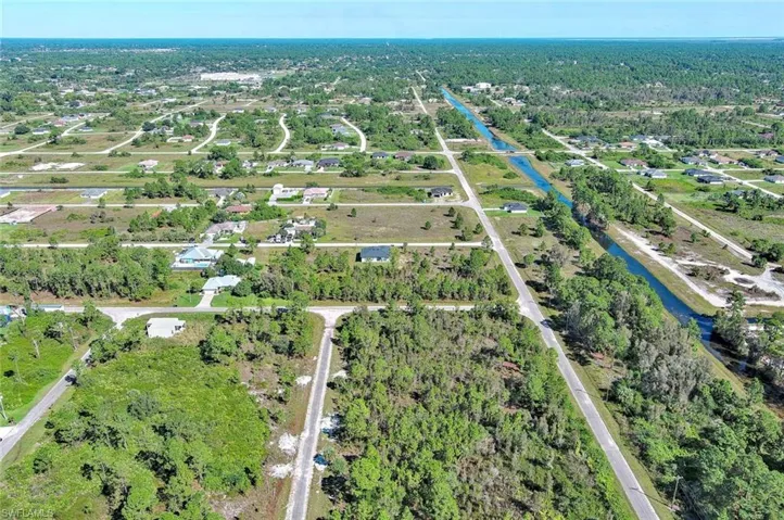 View of property location featuring a large body of water and nearby suburban area