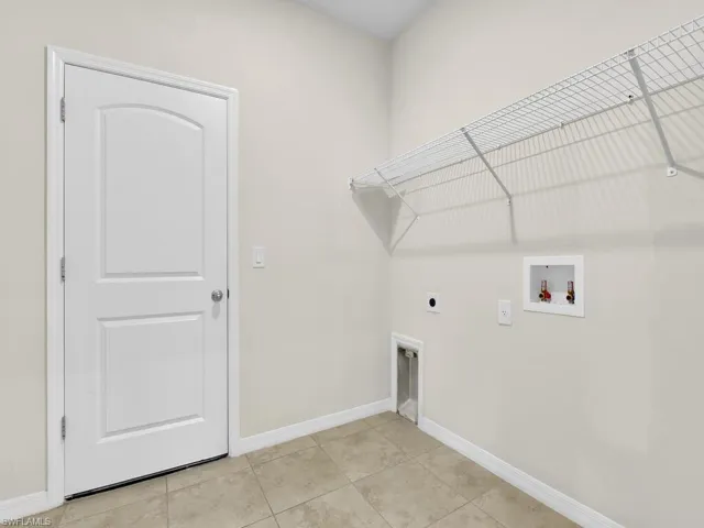 Laundry room with light tile patterned floors, electric dryer hookup, and washer hookup