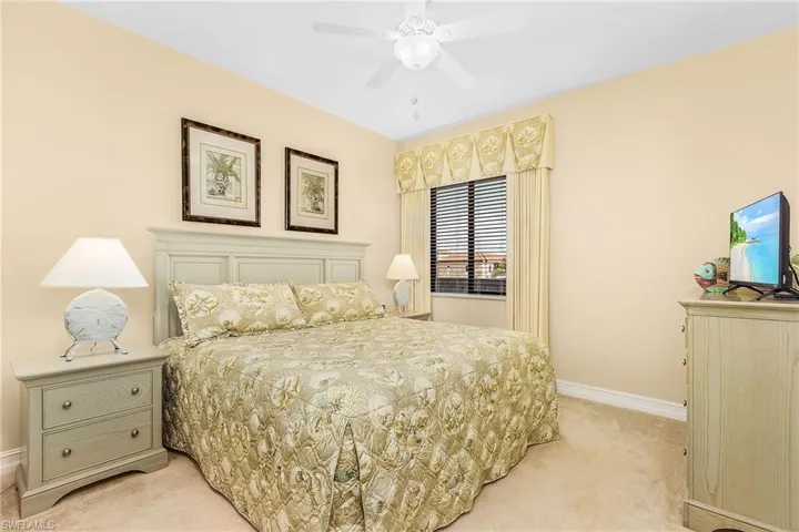 Bedroom featuring light carpet and baseboards