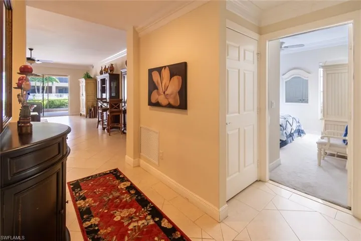 Hall featuring crown molding and light tile patterned floors