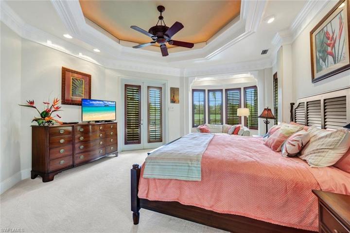 Master bedroom with recessed ceilings, built in plantation shutters, direct access to pool!