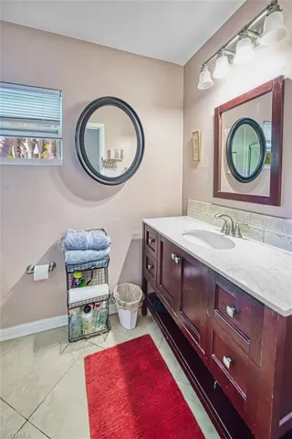 Half bathroom with vanity and backsplash