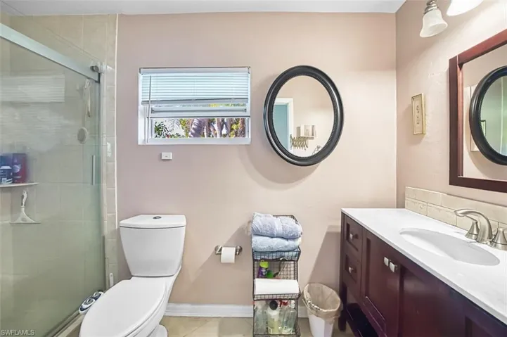 Full bathroom featuring vanity, a shower stall, and light tile patterned floors