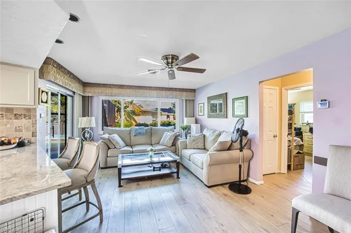 Living room with hardwood / wood-style floors and ceiling fan