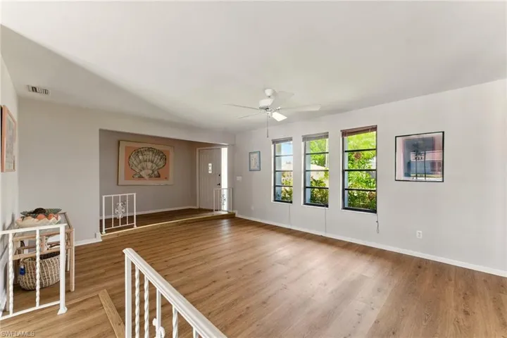 Looking from the dining area to the living room with natural light