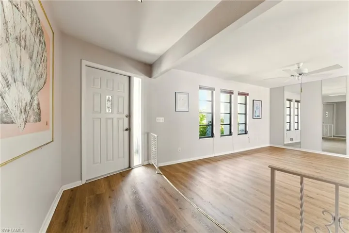 Entryway featuring luxury vinyl flooring and a stepdown into living area