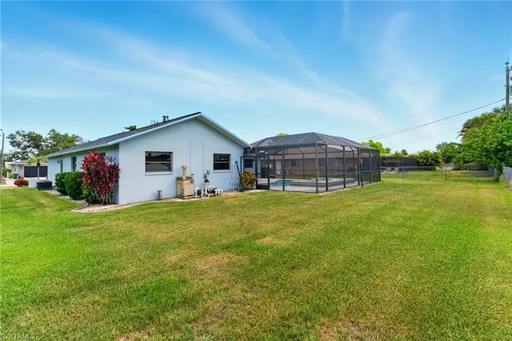 Rear view of property featuring a lanai and stucco siding